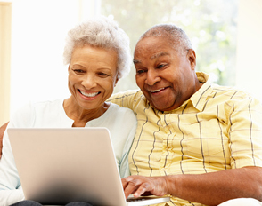 Senior African American couple using laptop